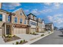 Attractive new townhome exteriors showcasing multiple levels and attached garages at 116 Via Roma, Woodstock, GA 30188