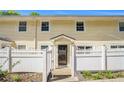 Charming two-story townhome with yellow siding and a white picket fence, creating a welcoming curb appeal at 2716 Suwanee Se Way, Marietta, GA 30067