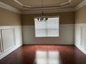 Formal dining room featuring decorative molding, hardwood floors and a chandelier for an elegant touch at 3648 Lake Estates Way, Atlanta, GA 30349