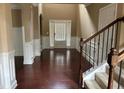 Elegant foyer with hardwood floors, a staircase, and a front door leading to the outside at 3648 Lake Estates Way, Atlanta, GA 30349