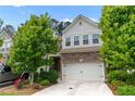 Inviting home exterior featuring a two-car garage, brick details, manicured landscaping, and a bright, welcoming facade at 6237 Thorncrest Dr # 10, Tucker, GA 30084