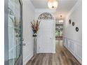Inviting foyer featuring wood-look flooring, wainscoting, decorative accents, and a view into the home's open layout at 6237 Thorncrest Dr # 10, Tucker, GA 30084