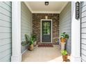 Charming covered front porch with brick accents, potted plants, and a welcoming entryway to the home at 6237 Thorncrest Dr # 10, Tucker, GA 30084