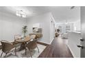 Bright dining area with stylish lighting and hardwood floors leading to a spacious living room at 10 Perimeter Summit Ne Blvd # 3109, Atlanta, GA 30319