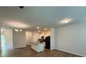 Spacious living room featuring hardwood floors, recessed lighting, and an open floor plan connected to the kitchen with an island at 2285 Crossrail Dr, Atlanta, GA 30349