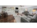 Cozy living room featuring a fireplace, built-in shelving, and hardwood floors at 4281 Chimney Lake Ne Dr, Roswell, GA 30075