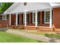 Inviting front porch with classic columns and brick accents at 4356 Executive Dr, Stone Mountain, GA 30083