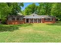 Beautiful brick home with a large front yard and a classic, timeless design at 4356 Executive Dr, Stone Mountain, GA 30083