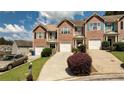 Desirable townhome complex featuring well-maintained lawns and attractive brick and siding exteriors on a sunny day at 5485 Sierra Trl, Atlanta, GA 30349