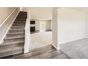 Welcoming entryway with staircase and blend of carpet and hardwood flooring at 8491 Limerick Ln, Winston, GA 30187