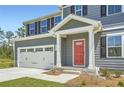 Inviting front porch with a vibrant red door, leading to a well-maintained two-story home at 8491 Limerick Ln, Winston, GA 30187