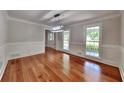 Formal dining room featuring hardwood floors, wainscoting and a modern pendant light at 2976 Matthew Ln, Lawrenceville, GA 30044