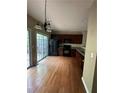 Spacious eat-in kitchen with hardwood floors, sliding glass doors and black appliances at 1466 Dolcetto Nw Trce # 18, Kennesaw, GA 30152