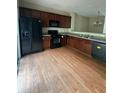 This large kitchen has wood floors, black appliances and plenty of cabinet space at 1466 Dolcetto Nw Trce # 18, Kennesaw, GA 30152