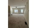 Bright living room features neutral walls, carpet, and a ceiling fan at 1466 Dolcetto Nw Trce # 18, Kennesaw, GA 30152