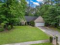 Well-maintained front yard featuring lush green grass and a charming brick and siding home at 1642 Ashmar Sw Ln, Marietta, GA 30064
