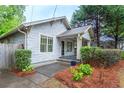 Side view of cozy home with lush landscaping and inviting front porch at 1761 Flat Shoals Se Rd, Atlanta, GA 30316
