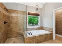 Luxurious bathroom with a soaking tub, separate shower, and elegant tile work at 2437 Camden Lake Nw Vw, Acworth, GA 30101