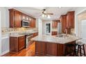 Well-equipped kitchen with stainless appliances, granite countertops, and cherry wood cabinetry at 2437 Camden Lake Nw Vw, Acworth, GA 30101