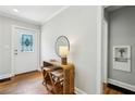 Inviting foyer with hardwood floors, decorative door, stylish console table, and neutral wall color at 1100 Faith Se Ave, Atlanta, GA 30316