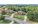 Beautiful home with a circular driveway on a landscaped lot, surrounded by mature trees at 2628 Hollow Pne, Conyers, GA 30094