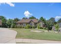 Inviting home with manicured lawn, tasteful landscaping, and a curved driveway at 2628 Hollow Pne, Conyers, GA 30094