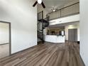 Open-concept living area showcasing hardwood floors, spiral staircase and an eat-in kitchen with bar seating at 390 17Th Nw St # 6001, Atlanta, GA 30363