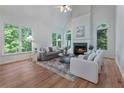 Bright living room with fireplace, hardwood floors, large windows, and ample seating for a comfortable gathering space at 1575 Wynridge Pointe, Alpharetta, GA 30005