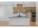 Stylish kitchen features a center island with bar seating, pendant lighting, and stainless steel appliances at 2560 Silver Star Ne Dr, Marietta, GA 30066