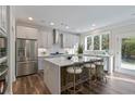 Open kitchen with stainless steel appliances, island with seating, and view to backyard at 2610 Lisa Sw Dr, Atlanta, GA 30311