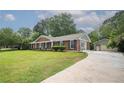 Well-maintained home with lush landscaping, detached garage, and long driveway at 599 Honey Creek Rd, Conyers, GA 30094