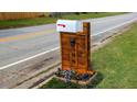 Unique wooden mailbox with house numbers, surrounded by colorful flowers at 599 Honey Creek Rd, Conyers, GA 30094