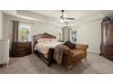 Serene main bedroom boasting a tray ceiling and elegant furnishings at 6235 Crescent Landing Dr, Cumming, GA 30028