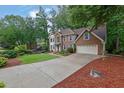 Beautiful brick home featuring a two-car garage and a long driveway with fresh landscaping at 4373 Mikandy Nw Dr, Kennesaw, GA 30144