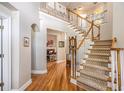 Grand foyer featuring a staircase, hardwood floors, and an open view to the living area at 5004 Lake Mist Se Dr, Smyrna, GA 30126