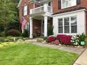 Beautiful brick home boasts a manicured lawn and colorful flowerbeds, enhancing its curb appeal at 5004 Lake Mist Se Dr, Smyrna, GA 30126