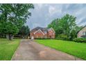 Traditional brick home with a long driveway and a spacious, well-manicured front yard at 5610 Mountain Meadow Ct, Stone Mountain, GA 30087