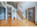 Spacious foyer with wood floors, staircase with iron railings, and decorative glass door at 5610 Mountain Meadow Ct, Stone Mountain, GA 30087
