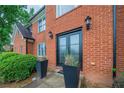 Close up of front entrance showing black double doors and a red brick facade at 5610 Mountain Meadow Ct, Stone Mountain, GA 30087