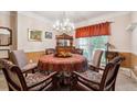 Elegant dining room featuring a chandelier, traditional furniture and a charming window at 1820 Habersham Gate Dr, Cumming, GA 30041