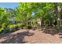 Well-maintained, lush front yard and mature trees offer ample shade on this stunning brick home at 1820 Habersham Gate Dr, Cumming, GA 30041