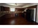 Well-equipped kitchen with dark wood cabinets, granite countertops, and stainless steel appliances at 545 Tulip Ln, Mcdonough, GA 30252