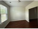Bright living room featuring hardwood floors, ample natural light, and neutral wall color at 545 Tulip Ln, Mcdonough, GA 30252