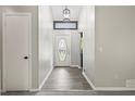 Bright foyer featuring updated flooring, an oval front door, and modern light fixtures at 9438 Cedar Creek Pl, Douglasville, GA 30135