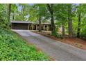 Charming home nestled in a wooded lot featuring a long driveway and brick facade at 2700 Regency E Dr, Tucker, GA 30084