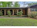 A charming brick home with arched windows and a well-manicured lawn at 2700 Regency E Dr, Tucker, GA 30084