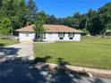 Classic single-story home with well-kept lawn and landscaping, showcasing its inviting curb appeal at 2875 Carriage Ln, Atlanta, GA 30349
