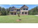 Charming two-story home with brick and siding, showcasing a well-kept lawn at 68 Homesite Cooper W Cv, Fayetteville, GA 30214