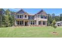 Attractive two-story home featuring a brick facade, siding accents, and a lush green lawn at 68 Homesite Cooper W Cv, Fayetteville, GA 30214