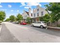 Street view of beautiful two-story homes with landscaped front yards and neighborhood street parking at 110 3Rd St, Fayetteville, GA 30214